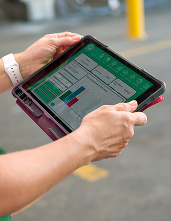 a person holding a tablet displaying data